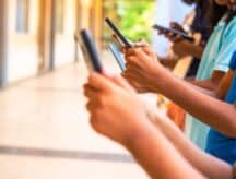 Image of users holding mobile phones in both hands