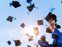 a group of new graduates celebrate at their graduation ceremony